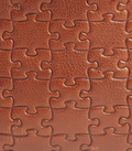 Nkari Brown · puzzle-embossed lychee leather swatch