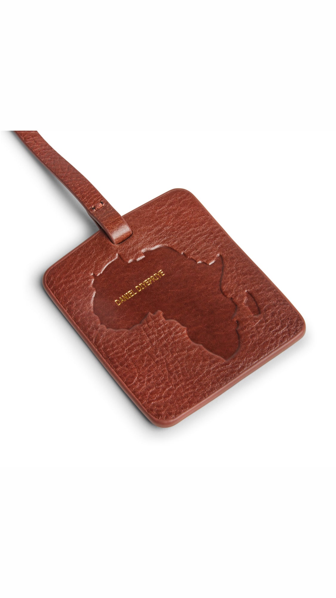 Nkari Custom Tag · Nkari waxed brown · Africa continent debossed · Daniel Diyepriye wordmark in gold