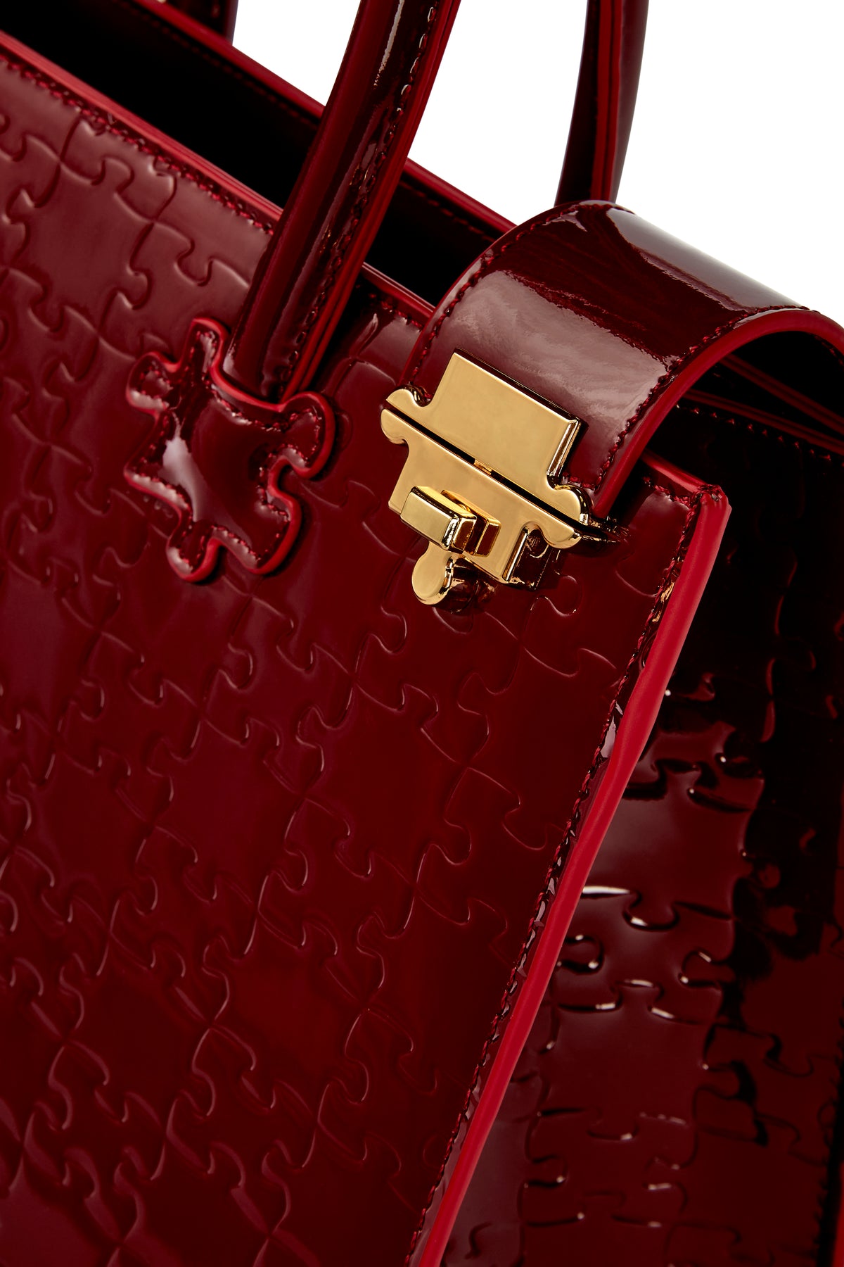 The Ibukun Tote — Burgundy Patent — gold flip-clasp detail