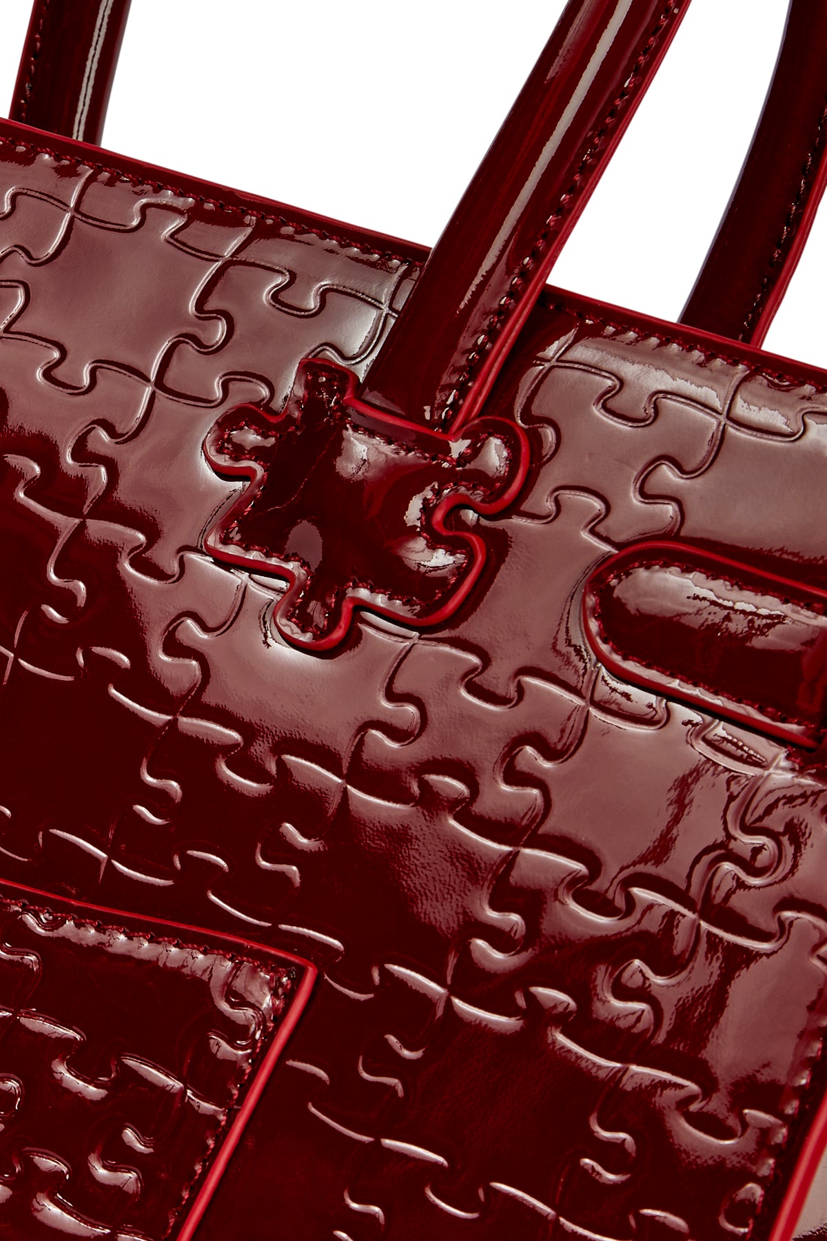 The Ibukun Tote — Burgundy Patent — puzzle-emboss close-up