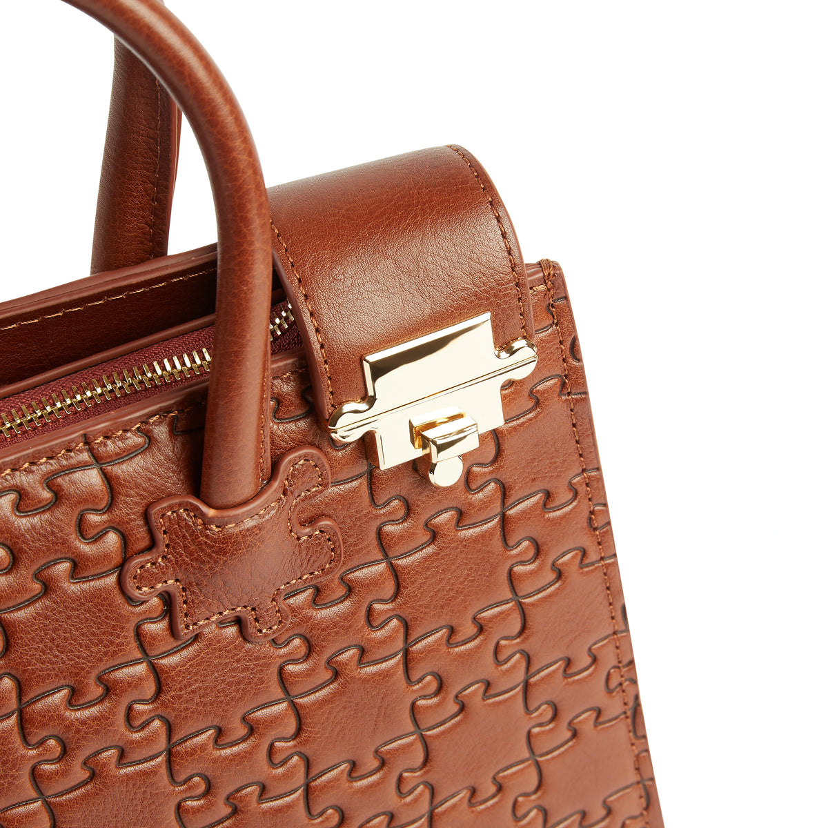 The Ibukun Tote in Nkari Waxed Brown · muted gold press-stud + zip hardware detail