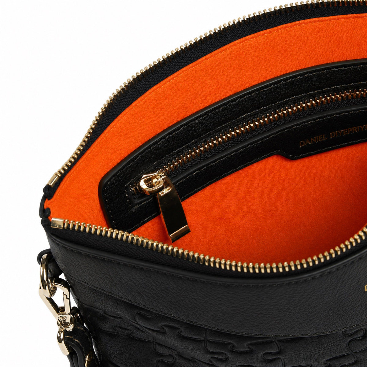 The Tomiwa Clutch Bag — Classic Black — interior with orange velvet lining