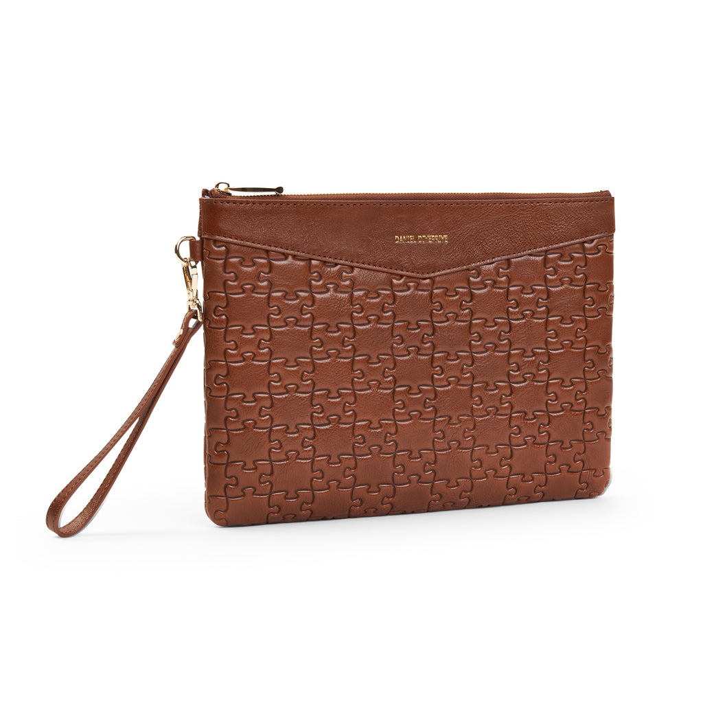 The Tomiwa Jigsaw Clutch — Nkari — front angle with wristlet strap